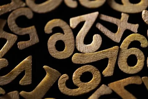 Close-up of Brass Numbers on Black Background in Random Arrangement Stock Photos