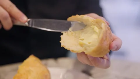 Close up bread being buttered, fresh rolls. 4K 24FPS Stock Footage 250949042