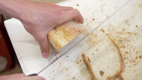 Close up of bread being sliced for appetizers in restaurant Stock Footage 336793341
