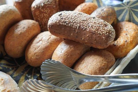 Close-Up of Bread Buns with Serving Tongs Stock Photos