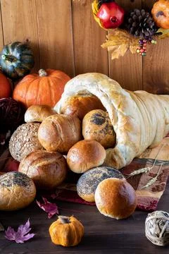 Close up of a bread cornucopia overflowing with rolls. Stock Photos