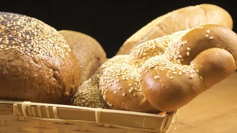 Close-up.Bread of different kinds lies in the basket and spins on the table Stock Footage 76507077