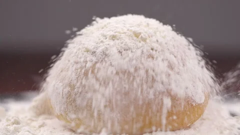 Close-up of bread falling on table close-up in flour placer Stock Footage 132227435