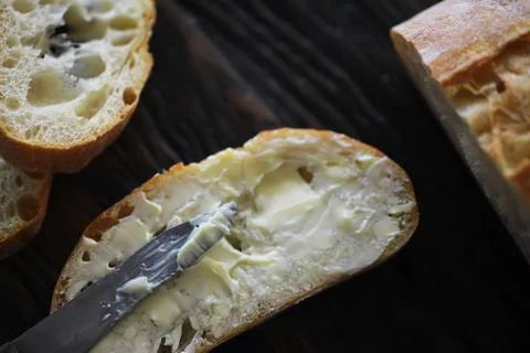 Close-up of Bread Slice with Butter Spread on Rustic Wooden Table Stock Photos