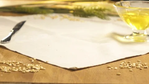 Close-up. Bread sprinkled with sunflower seeds is put on the table Stock Footage 76423165