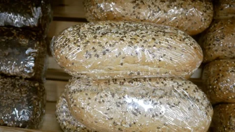 Close up bread supermarket. Assortment of packaged bread. Rows of warm freshly b Stock Footage 266402334