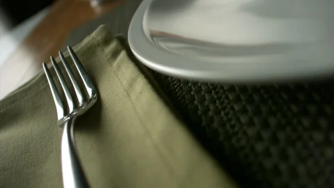 Close-up breaded chicken nuggets fall on a plate lying next to a fork Stock Footage 113625360