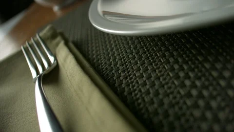 Close-up of breaded chicken nuggets falling on a plate lying next to a fork Stock Footage 113624766