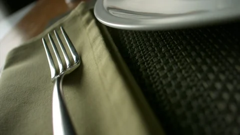 Close-up of breaded nuggets falling on a plate lying next to a fork Stock Footage 113624253