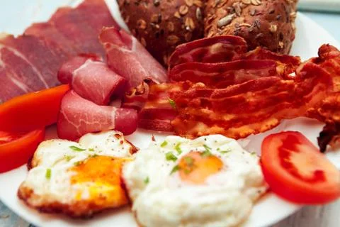 Close up of breakfast with eggs, bacon and integral buns-Chrono diet Stock Photos