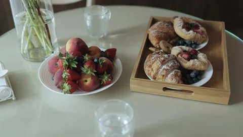 Close-up of breakfast. Kitchen with delicious breakfast buns and croissant with Vídeos de archivo 255784086