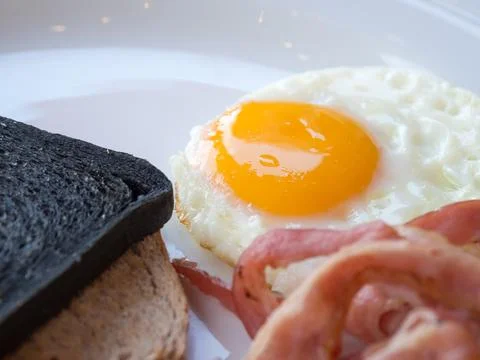 Close up breakfast with nutritious have Bread Charcoal,toast,bacon and egg .. Stock Photos