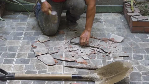 Close-up breaking the tile of a floor of a house to dig Stock Footage 150669155