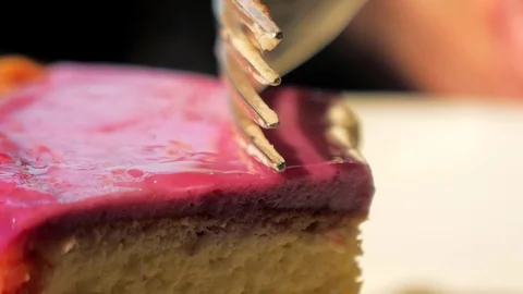 Close-up of breaks off a piece of cheesecake with a fork. Fork on the piece of Stock-Footage 122999907