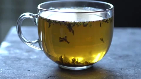 Close-up of brewed tea, floating teapots Stock Footage 139645556