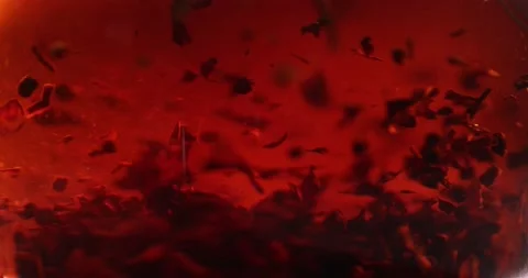 Close-up of brewing of red tea. Macro shot of tea leaves floating in boiling Stock-Footage 172208345