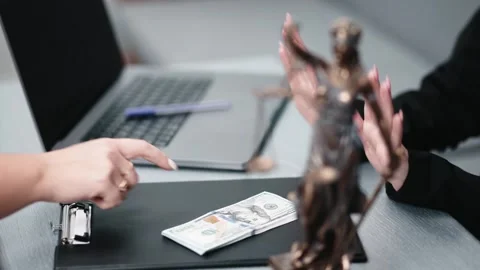 Close-up of a bribe being offered to a lawyer in their office. Stock Footage 297322178