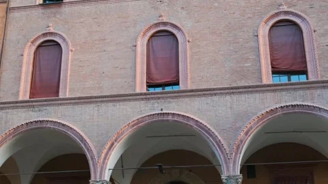 Close up of brick facade of historic building with arched porticoes, red Stock Footage 295113273