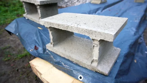 Close up of a brick laid on a blue plastic Stock Footage 158976544