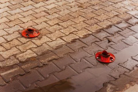 Close up of brick pavement with knocked -down road plastic column Stock Photos