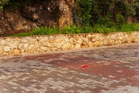 Close up of brick pavement with knocked -down road plastic column 写真素材