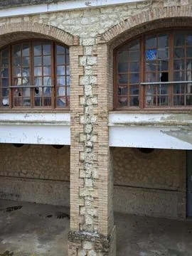 Close up of a brick pillar with arched windows and broken glass at Borja sa.. Stock Photos