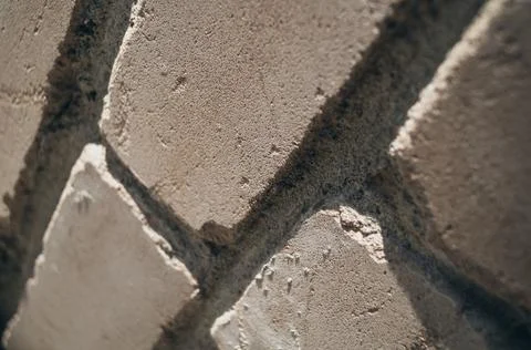 Close-up of the brick wall at an angle. Blurry areas of the frame, graininess. Stock Photos