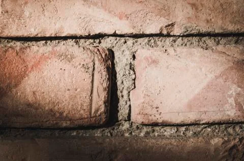 Close up of a brick wall with harsh light from the upper left Stock Photos