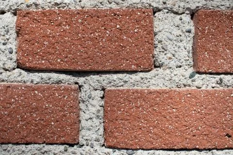 Close up of brick wall with red bricks with cement in between Stock Photos