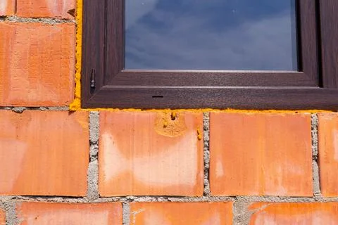 Close-Up of Brick Wall with Window Reflecting Sky Stock Photos
