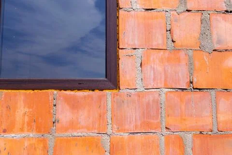 Close-Up of Brick Wall with Window Reflecting Sky Stock Photos