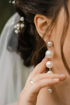 Close-up, the bride adjusts her earring Stock Photos