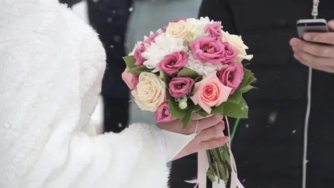 Close up of bride and groom standing outdoors. Bride with a bouquet of flowers, Stock Footage 104548254