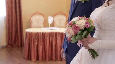 Close up of bride and groom standing indoors on the registery table background Stock Footage 104549133