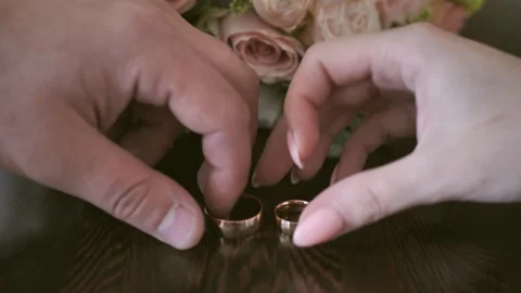Close-up of the bride and groom's hands taking their wedding rings Stock Footage 159949185