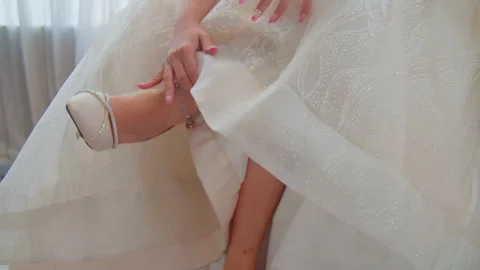 Close-Up Bride Fixing Her Shoes on Wedding Day in Elegant Moment Stock Footage 333375346