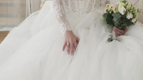 Close-up of a bride gently touching her wedding dress Stock Footage 317077699