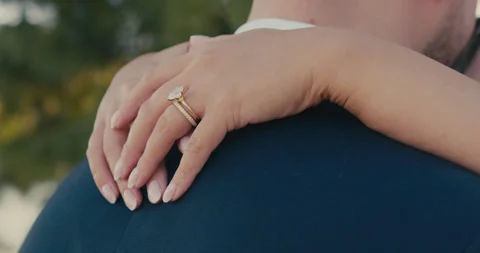 A close up of the bride hands gently embracing her groom as they look tenderly Video stock 321621351