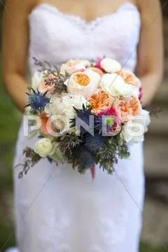 Close up of bride holding bouquet of flowers Stock Photos