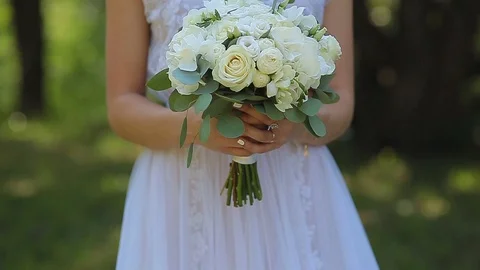 Close-up of a bride holding her wedding bouquet. Stock Footage 82585252