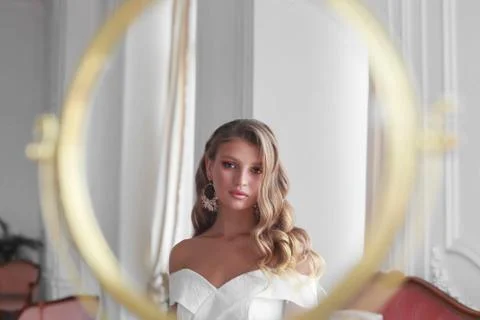 Close-up of a bride looking in a mirror before wedding ceremony Stock Photos