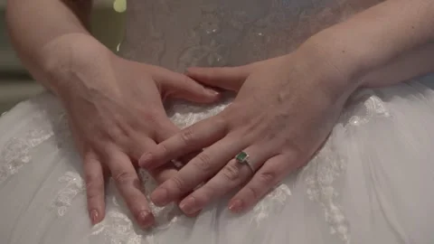 Close up of a bride touching her detailed lace wedding dress while preparing Stock Footage 342477756