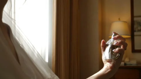 Close up of bride using perfume on her wedding day at a hotel room. Anonymous Stock-Footage 107451115