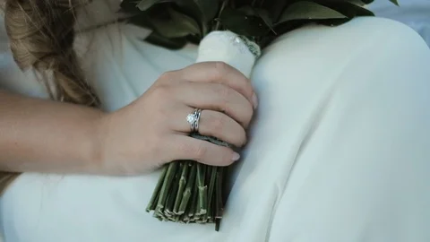 Close up bride with wedding ring against a background of flower composition. Stock Footage 92586814