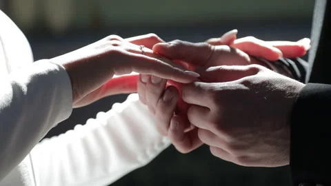 A close-up of the brides and grooms hands as, on their wedding day, he places Stock Footage 321831809
