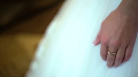 Close-up of bride's hand corrects the puffy white skirt. Wedding dress details Stock Footage 73110384