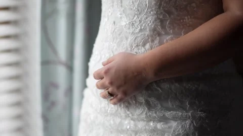 Close up of brides hand standing in a window frame Stock Footage 278047491