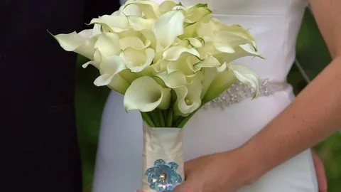 Close up of a brides hands holding her wedding bouquet Stock Footage 87295347