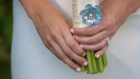 Close up of a brides hands holding her wedding bouquet Stock Footage 87295366