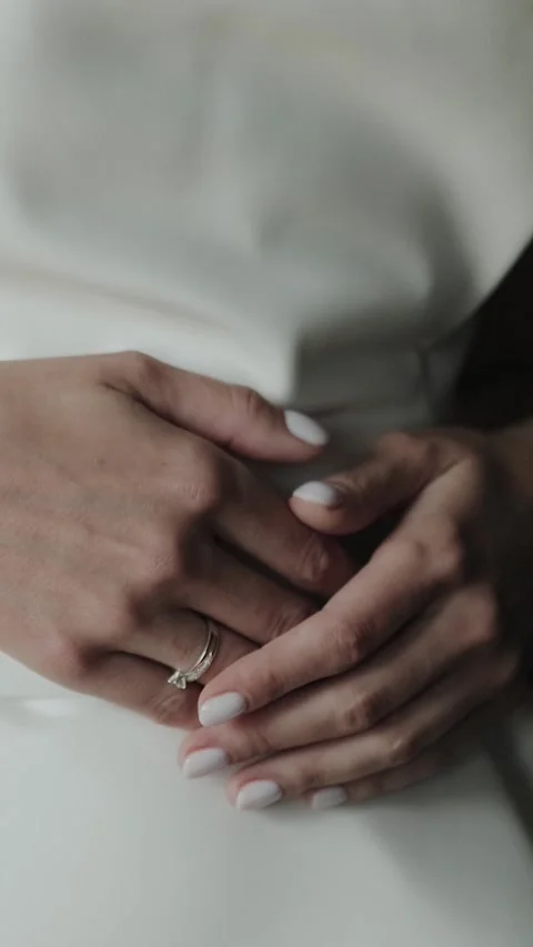 Close-up of the bride's hands holding them on her stomach.Wedding ring on the Stock Footage 308395605